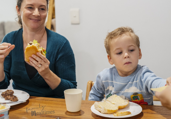 Family sits around a table enjoying a peaceful family meal