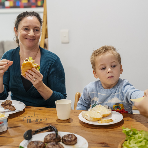 Family sits around a table enjoying a peaceful family meal